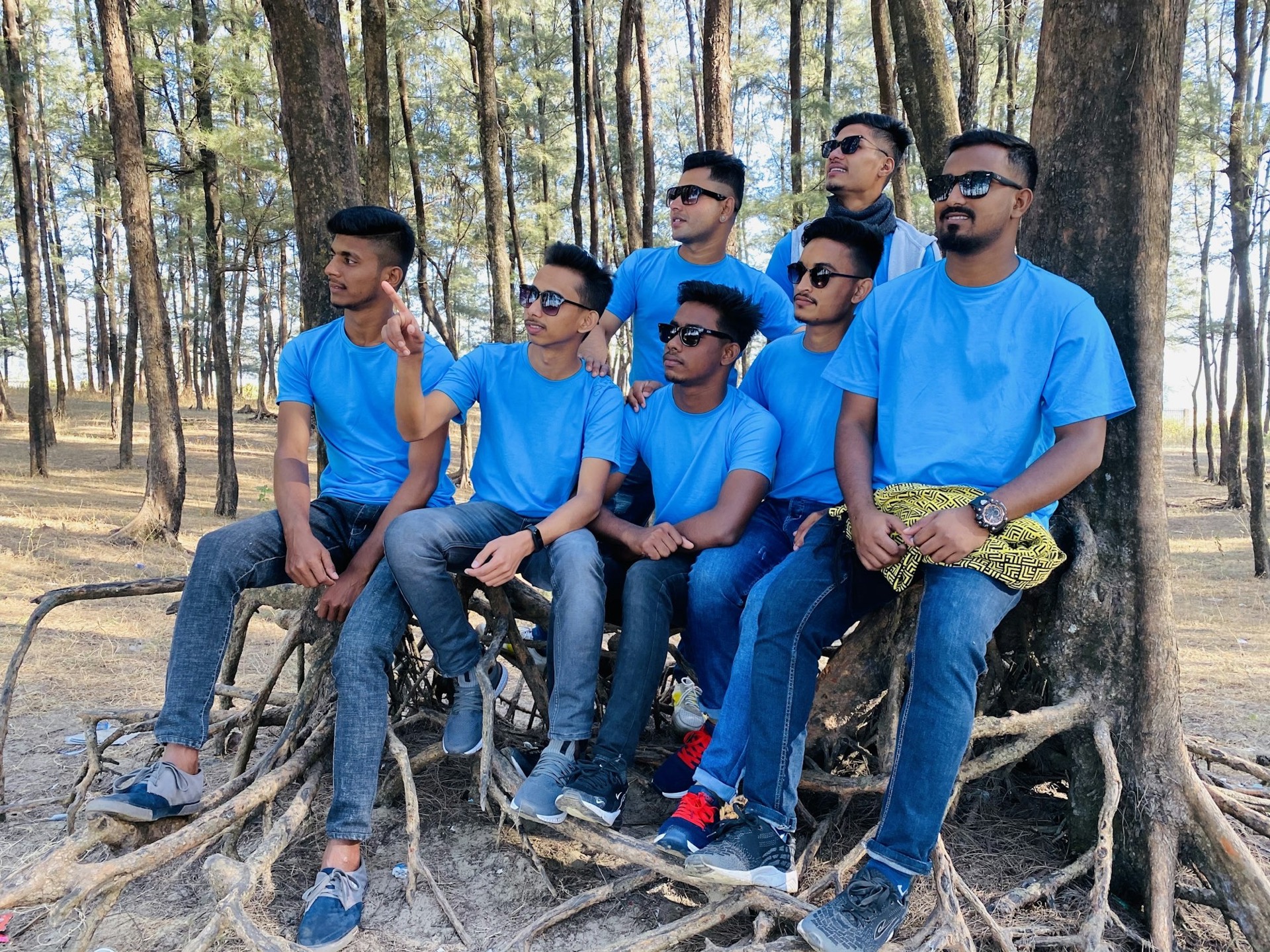 A group of young men in matching sky-blue T-shirts