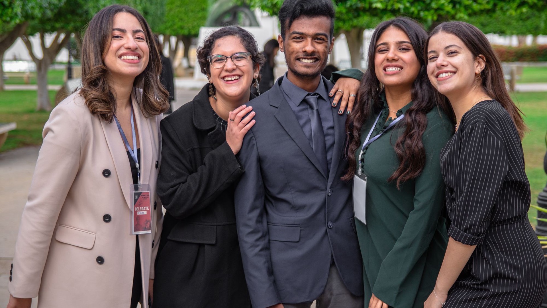 A group of young professionals in formal wear at a conference